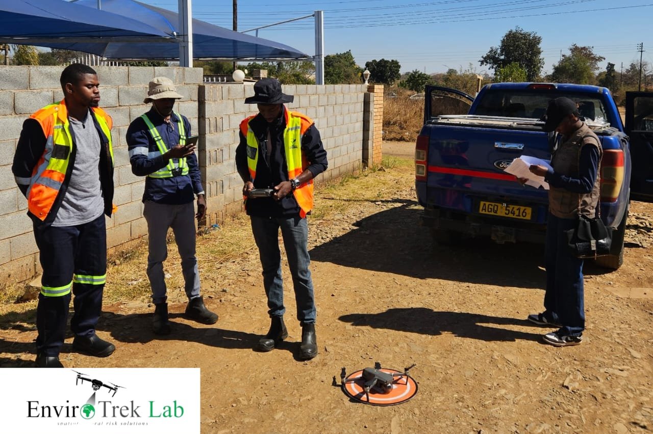 EnviroTrek Lab team preparing a drone for take-off from a landing pad