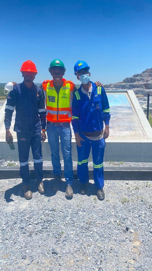 EnviroTrek Lab consultant with site personnel at an open-pit mine lookout